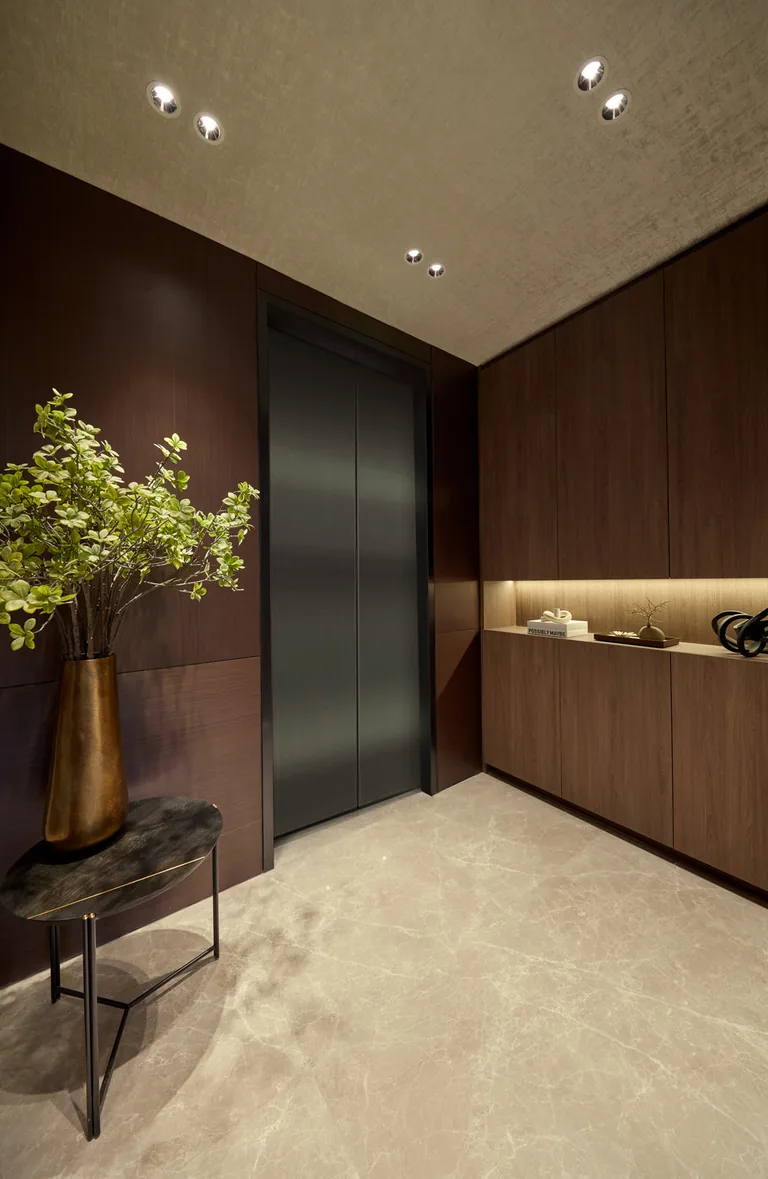 Private lift lobby of a Prestige Collection home at Terra Hill, with timber panelling and a console (show unit photograph, for illustration only)